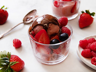 strawberry ice cream sundae with chocolate sauce on top